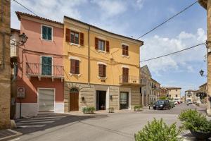 a yellow and orange building on a city street at CAMERANOAPARTMENTS - L'Angolo della Piazza in Camerano