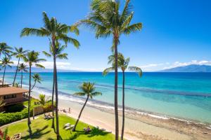a view of a beach with palm trees and the ocean at Paki Maui 405 in Honokowai