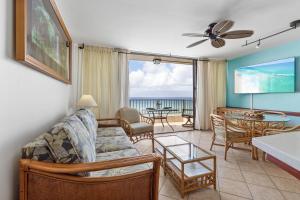 a living room with a couch and a table at Paki Maui 405 in Honokowai +24 photos