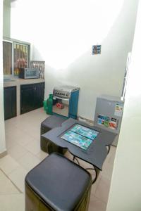 a kitchen with a table and a machine in it at "La Coquille", joli loft, moderne, propre, sûr et calme au cœur de Saly in Saly Portudal