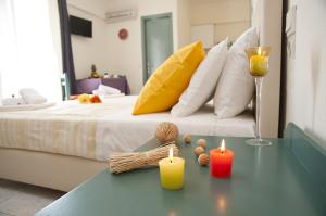 a bedroom with a bed with two candles on a table at Selena View Studios in Malia