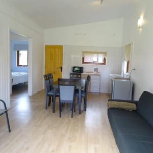 a living room with a couch and a table and chairs at CasaMisur in Puerto Varas +13 photos