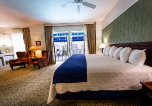 a hotel room with a bed and a balcony at The Hotel Paisano in Marfa