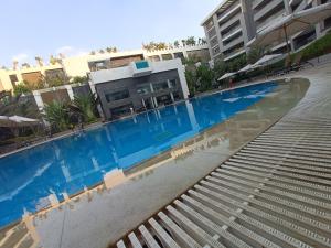 a swimming pool with stairs in front of a building at Sheraton Ocean 601-B - Private apartments in Cairo