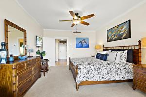 a bedroom with a bed and a ceiling fan at Kapalua Golf Villa 15T 7&8 in Kahana +44 photos
