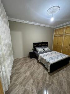 - une chambre avec un lit et un rideau dans l'établissement Chez mimoun, à Berkane