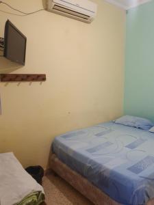 A bed or beds in a room at Hotel Hostal Caballito Blanco