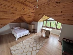 a bedroom with a bed and a desk in a attic at Mimoza Park House in Trabzon