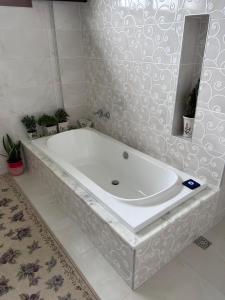 a white bath tub in a bathroom with a mirror at Mimoza Park House in Trabzon