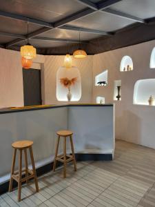 a counter in a restaurant with two stools at Soykan Hotel in Marmaris