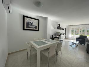 a living room with a white table and chairs at Casa Olé in Jávea