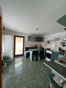 a kitchen with green cabinets and a counter top at Pensiunea Casa Ana in Agapia