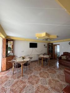 a living room with two tables and a couch at Pensiunea Casa Ana in Agapia