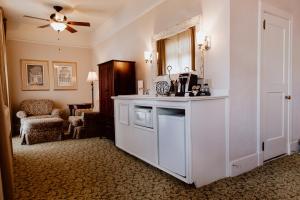a room with a kitchen with a counter and a ceiling fan at The Hotel Paisano in Marfa
