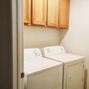 a small laundry room with a washer and dryer at Nice Private Room Near Red Rock & Las Vegas Strip in Las Vegas