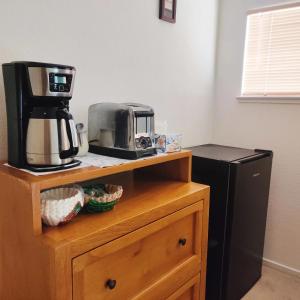 a coffee maker on top of a wooden cabinet next to aether at Nice Private Room Near Red Rock & Las Vegas Strip in Las Vegas