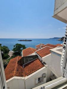 a view of roofs of buildings and the ocean at The View Sveti Stefan V2 in Sveti Stefan