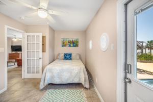 a bedroom with a bed and a sliding glass door at Blue Horizon HUGE Private Pool and yard with Outside shower! in Port Aransas