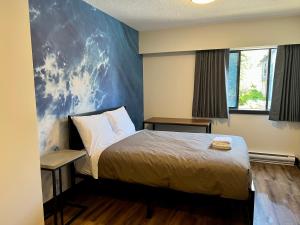 1 dormitorio con cama y pared azul en HI Vancouver Downtown - Hostel, en Vancouver