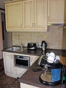 a kitchen with a sink and a counter top at Cosy Apartment near Faaker See in Latschach