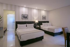 Kama o mga kama sa kuwarto sa Las Lomas Casa Hotel