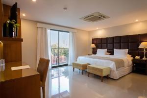 Kama o mga kama sa kuwarto sa Las Lomas Casa Hotel