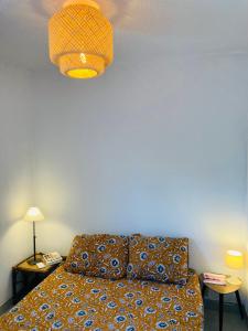 Postel nebo postele na pokoji v ubytování Bienvenue chez Méli et Dorian