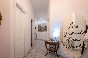 a hallway with a mirror and a table with a lamp at Nervi residenziale a due passi dal mare in Genova +13 photos