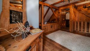 a room with wooden walls and wooden floors and a wooden table at KUĆA ZA ODMOR DANICA in Čabar
