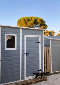a gray garage with a door on a building at Estera Tent Camping in Zadar