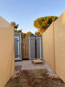 a backyard with a fence and a garage at Estera Tent Camping in Zadar