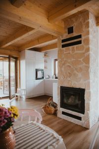 a living room with a stone fireplace at House Polesie in Urszulin