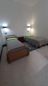 a room with two beds in a room at CASA VACANZE NONNA ROSETTA in Menfi