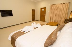 Postelja oz. postelje v sobi nastanitve Syailendra Hotel Syariah