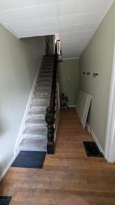a staircase in a house with a stair case at Historic Row House in Elmira