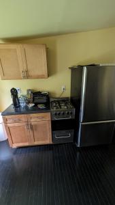 a kitchen with a stove and a refrigerator at Historic Row House in Elmira