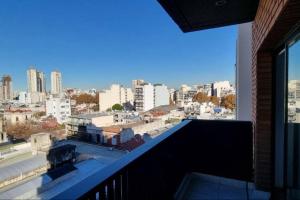a view of a city skyline from a balcony at Studio con amenities en Palermo - Recoleta in Buenos Aires