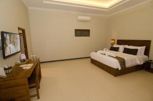 Postelja oz. postelje v sobi nastanitve Syailendra Hotel Syariah