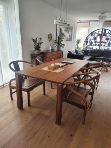 a wooden table and chairs in a living room at FeWo Interlaken in Interlaken