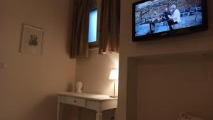 a television hanging on a wall in a room at Dimora Rosantica in Ariano Irpino