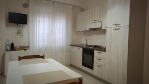 a kitchen with wooden cabinets and a white counter top at Dimora Rosantica in Ariano Irpino