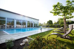 a house with a swimming pool in a yard at Kur- und Feriencamping Max 1 in Bad Füssing