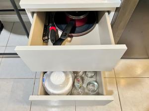 a drawer in a cabinet filled with utensils at Modern 1 Bedroom Home W/ Sauna & Shower-Jets in Carson