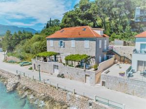 a house on the side of a river at Seafront apartment Marina2 in Jelsa