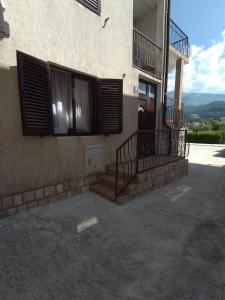 a building with stairs and windows on the side of it at Igalo Apartman Despich in Igalo