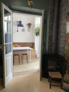 a kitchen and dining room with a table and a fireplace at Casa dos Poetas in Caldas da Rainha