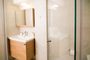 a bathroom with a sink and a shower at G&K House View in Messini