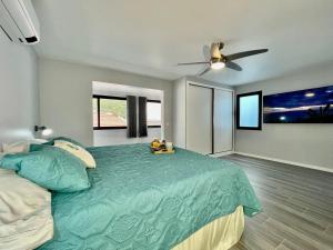 a bedroom with a bed and a ceiling fan at Ocean Front in Paul do Mar