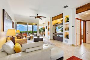 a living room with a white couch and a ceiling fan at Kapalua Bay Villa 33G4 in Kahana