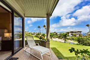 a white chair on a porch with a view of a yard at Kapalua Bay Villa 33G4 in Kahana